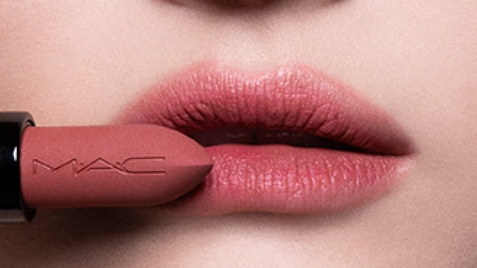 Closeup of model applying our iconic Velvet Teddy Matte Lipstick